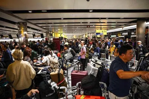 受英国航班处理系统故障影响，周二有大批旅客因航班延误或取消，滞留在伦敦希思罗机场3号航站楼。（法新社）