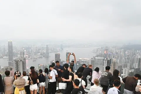 香港是著名购物天堂，但在多年前因“零团费”不时发生强迫大陆旅客购物的冲突。图为旅客在香港太平山山顶欣赏维港风光。（中新社）