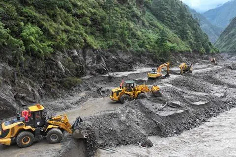 尼泊尔与中国西藏边境8月26日发生严重泥石流灾害，造成西藏吉隆口岸多人伤亡和失联。图为工人8月28日抢修通往吉隆口岸的一段道路。（法新社）