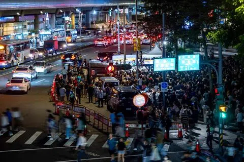 台湾民众10月6日在台北剑潭捷运站附近一场竞选活动上，观看台北市长候选人沈伯洋的竞选活动。（法新社）