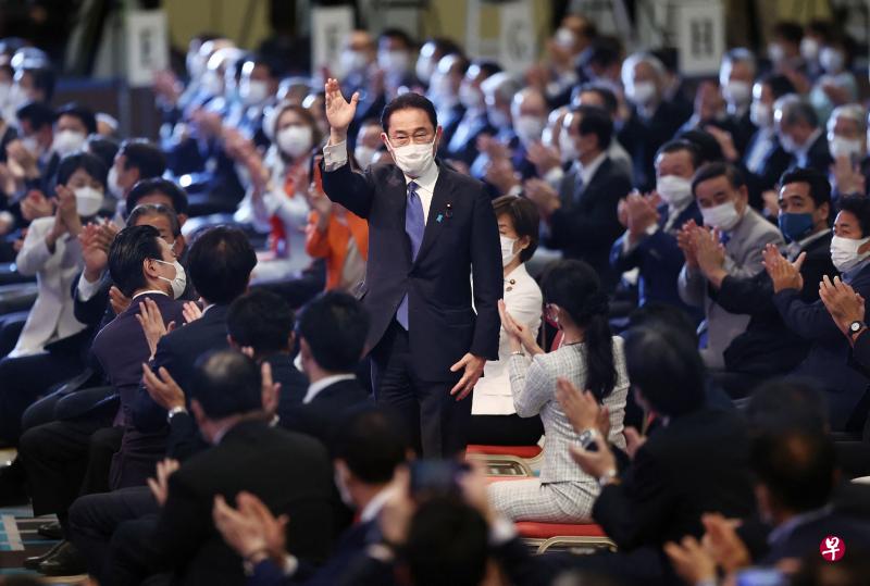 即将成为日本第100任首相的岸田文雄在自民党总裁选举中获胜后，向支持者挥手致谢。他被指获得前首相安倍晋三及副首相麻生太郎等支持，因此上台后的政策将离不开安倍路线。（法新社）
