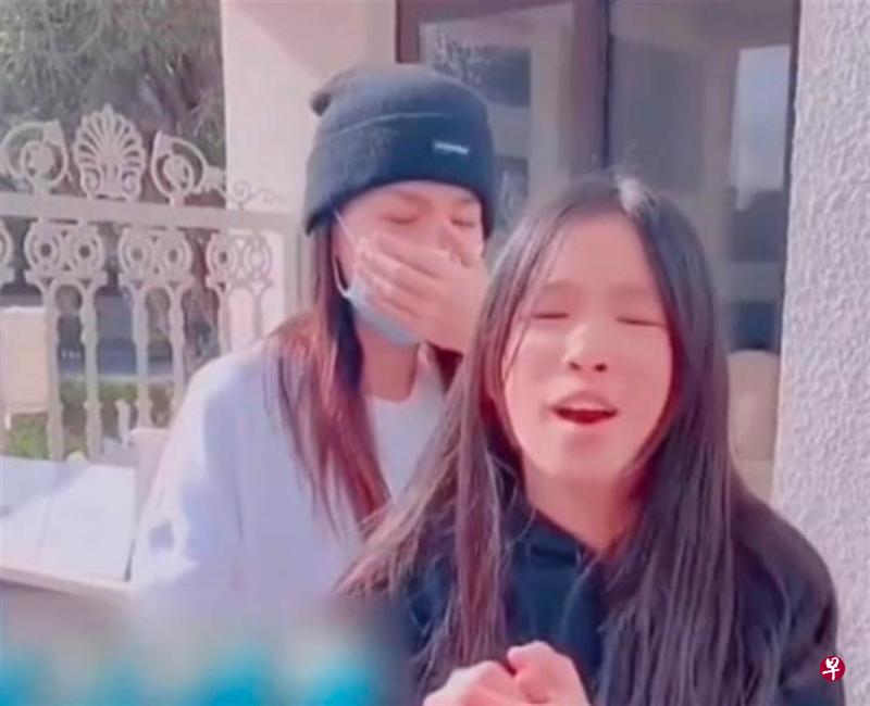当女儿在镜头前恳请网民原谅时，在后头的张庭忍不住捂脸哭泣。（微博图）