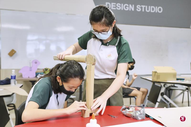 绿苑中学学生在工作坊中，利用纸板制作模型，帮助人们安全可靠地从天花板取下竹竿，解决生活中的实际困难。模型末端有一个把手，可以牢牢固定竹竿，防止竹竿砸到人。（詹姆士戴森基金会提供）