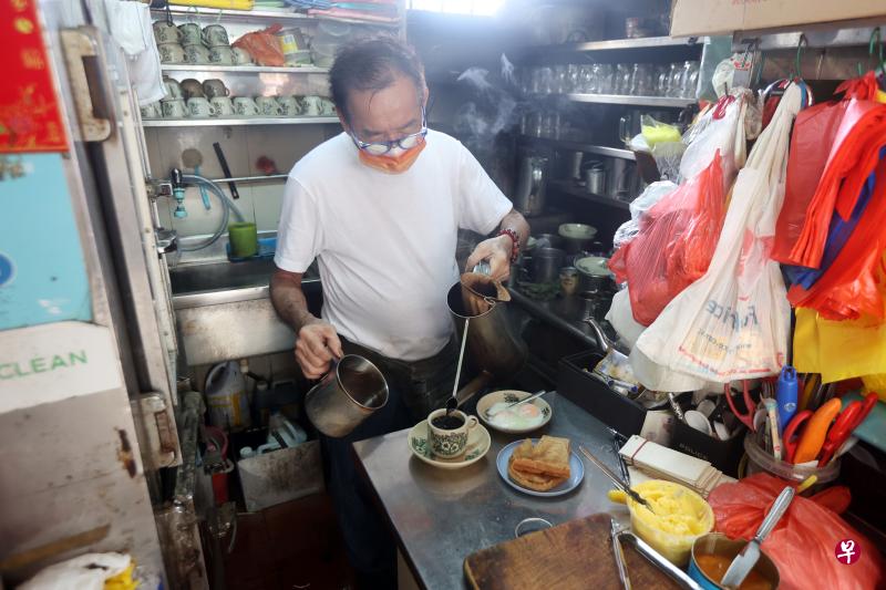 加冷惹兰百纳安克巴熟食中心的茶水摊摊主杨忠翮年届古稀仍十分健朗，每天摸黑从盛港的住家抵达摊位，数十年来如一日地为顾客提供热腾腾的廉价早餐。（饶进礼摄）