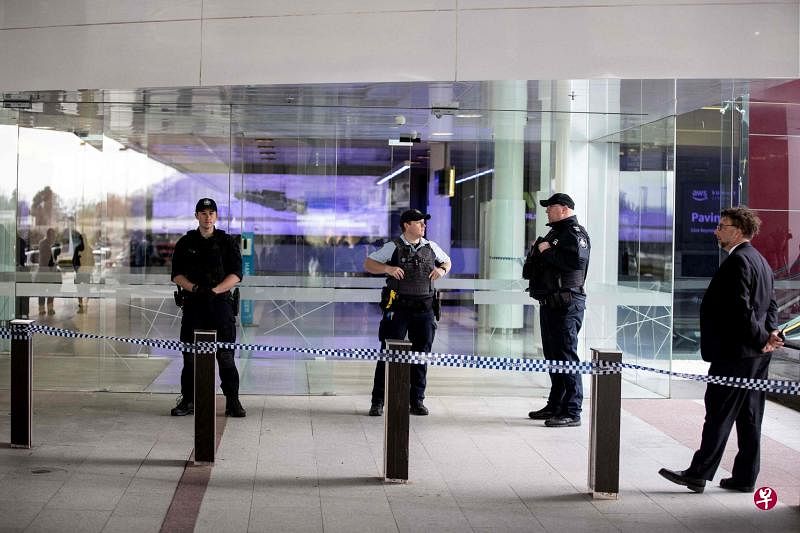 澳洲首都堪培拉机场搭客大厦发生开枪事件后，警方迅速封锁了机场。图为警员在搭客大厦入口处驻守。（法新社）