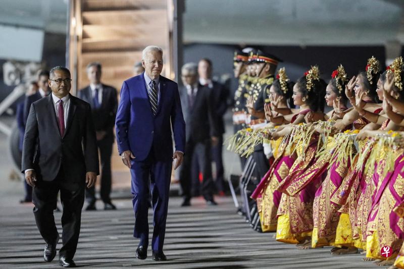 美国总统拜登（右）星期天晚从柬埔寨金边飞抵印尼峇厘岛，G20峰会主办当局以民族舞蹈欢迎他。（路透社）