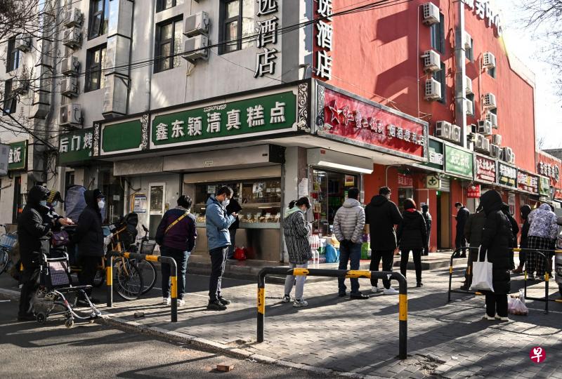 在北京市一个药房外，民众11日排队买药。（法新社）