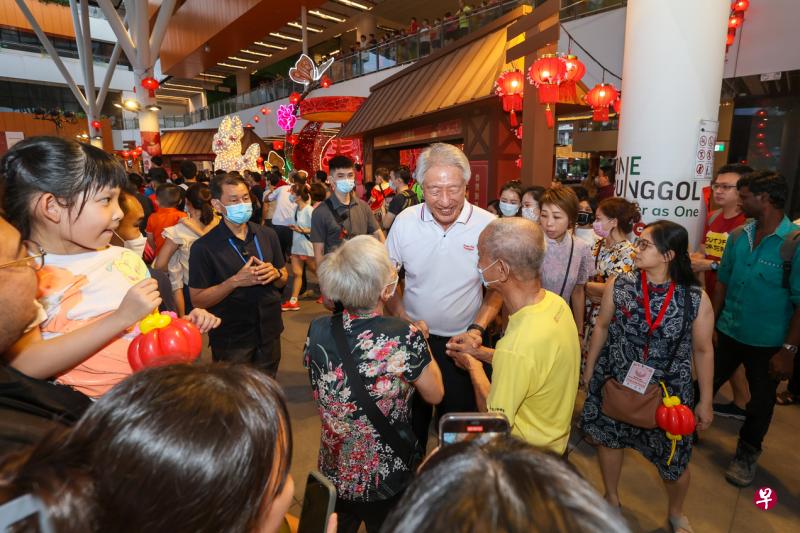 出席榜鹅镇农历新年庆祝会的白沙—榜鹅集选区议员、国务资政兼国家安全统筹部长张志贤（中间白色上衣者）与民众交谈。（卓祾祎摄）