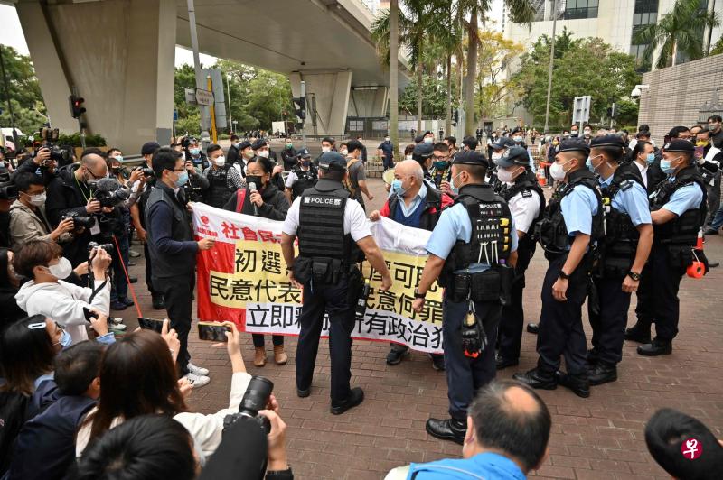 香港47名泛民主派人士被控“串谋颠覆国家政权罪”星期一（2月6日）在西九龙裁判法院开审，社会民主连线成员在法院外举横幅抗议“初选无罪、打压可耻”。（法新社）