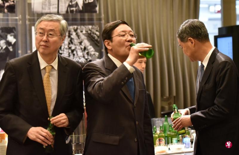 香港交易所昨天举行“新时代香港资本市场再出发”研讨会，主办方特意安排在会议休息期间提供青岛啤酒，唤起大家对香港资本市场发展历史的回忆。1993年7月15日，青岛啤酒在香港联交所上市，成为中国大陆第一家在港上市的企业。图为与会嘉宾周小川（左起）、楼继伟和梁振英在喝青岛啤酒。（中通社）