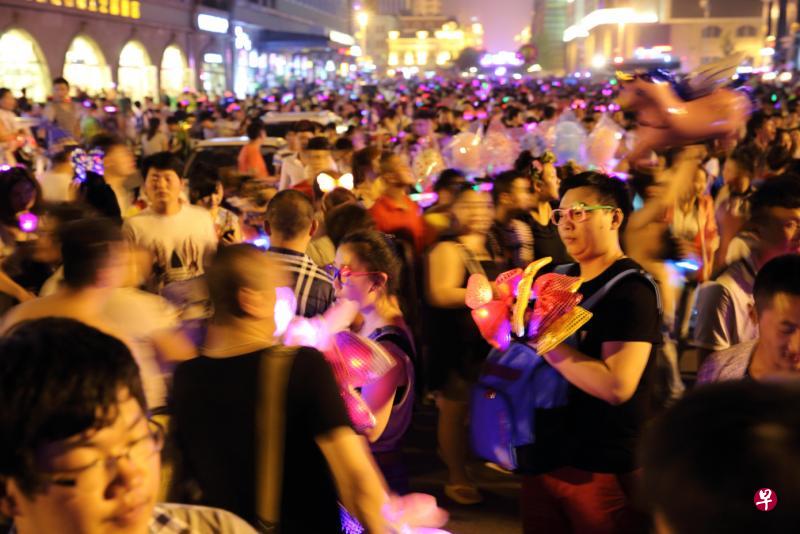 荧光波动的夜，簇拥往来的人。