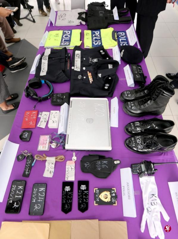 警方展示嫌犯这三年来购买的“干案道具”，包括警察外套、警章、警鞋、对讲机等，应有尽有。（中国报）