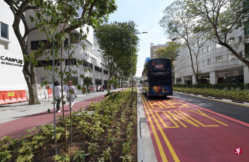 明古连街原有四条车道，两条改建为宽敞的人行道和脚踏车道，剩下的两条，一条划为巴士道，只剩一条车道留给汽车。以后有更多道路会让巴士享有优先行驶权。（海峡时报）