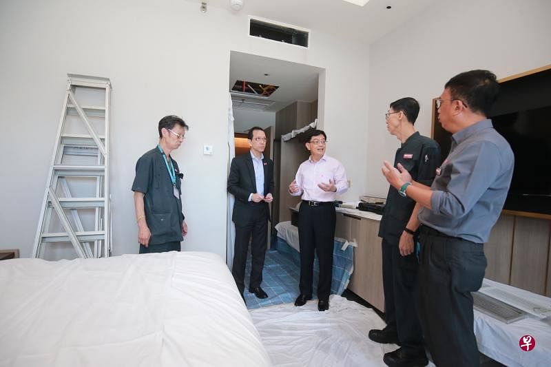 副总理王瑞杰（中）向吉真宾乐雅酒店总经理翁敦杰（左二）及维修团队了解酒店所采取的客房防御性维修程序。（唐家鸿摄）