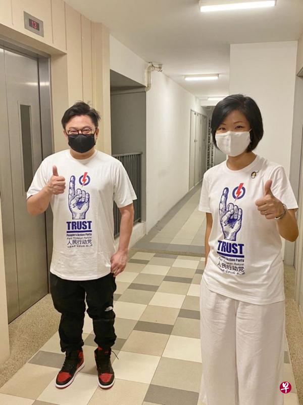 沈颖（右）穿上本地著名设计师和艺术家罗杰瀚设计的竞选T恤与他合照。（取自沈颖面簿）