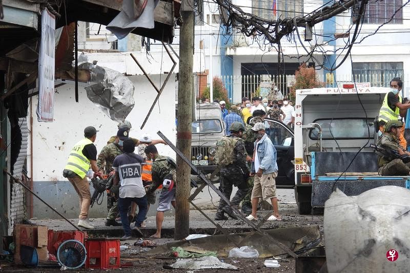 菲南的霍洛市中心一家食品店外（图），昨天发生炸弹爆炸，死伤严重，倒下的多数是军警人员。（法新社） 