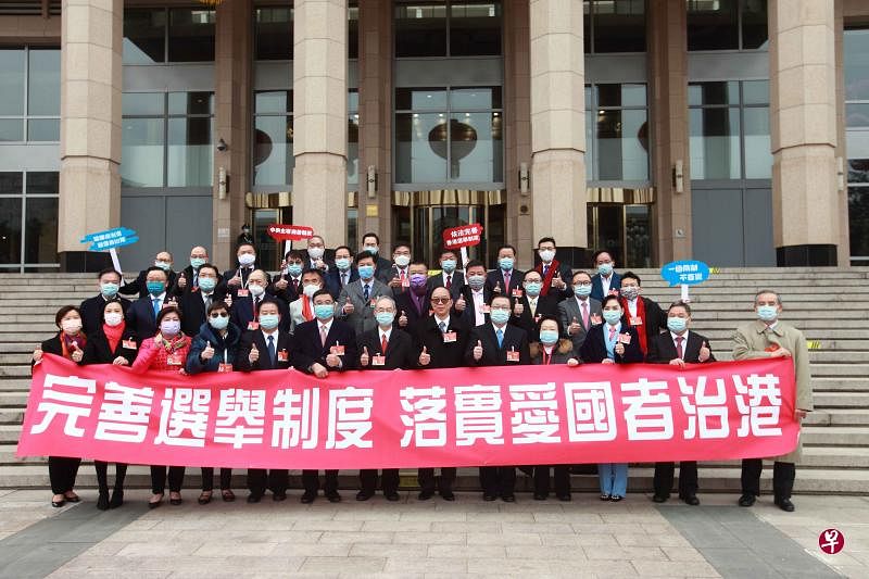香港特别行政区人大代表团今天（5日）在北京人民大会堂外合影。他们当天发表声明称，完善香港特区选举制度，是落实行政主导体制、确保特区有效管治的必要之举。十三届全国人大四次会议当日在北京开幕。（中新社）