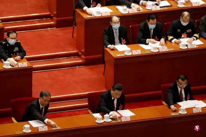中国全国政协主席汪洋（前排左起）、中国国家主席习近平与中国总理李克强昨天为改革香港选举制度的人大决定议案投票。（路透社）