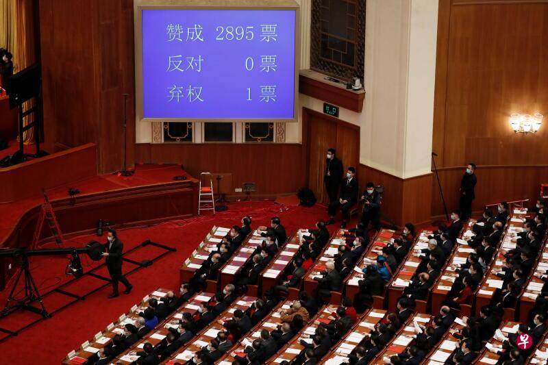 中国全国人大会议以2895票的高票表决通过了完善香港选举制度决定草案。（路透社）