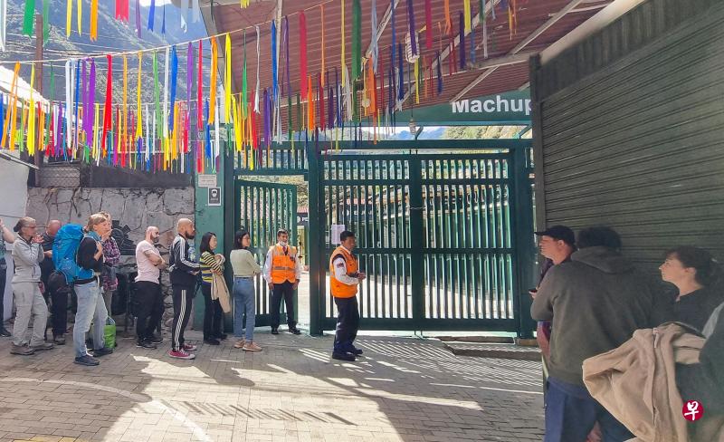 马丘比丘城镇因示威活动而暂停服务，受困当地的游客在火车站外排队等候。（法新社） 