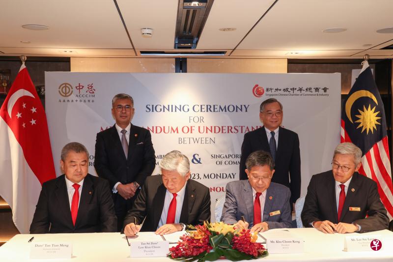 新加坡中华总商会会长高泉庆（右二）和马来西亚中华总商会会长卢成全（左二）在颜金勇（第二排右边）和东姑扎夫鲁（第二排左边）的见证下，代表签署备忘录。新加坡中华总商会第二副会长李思亮（右一）和马来西亚中华总商会秘书长拿督陈镇明（左一）也参与签约仪式。（李冠卫摄） 