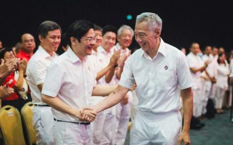 人民行动党秘书长李显龙总理（前排右）在行动党大会上，与行动党副秘书长黄循财（前排左）握手。黄循财也是副总理兼财政部长。后排白衣者是行动党助理秘书长、教育部长陈振声（左起）；行动党中委、全国职工总会秘书长黄志明；行动党中委、阿裕尼集选区基层组织顾问杨陞才，以及国务资政兼国家安全统筹部长张志贤。（取自行动党脸书）