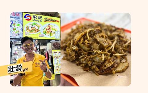 “梁记”老板梁金义一身鲜黄，成为顾客记住他的标志。（林安娜/翁铭芯摄）