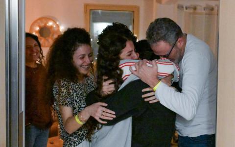 去年1月，以色列人质朱宁（中）获释后，在特拉维夫附近一处医疗中心与家人相拥团聚。（法新社）