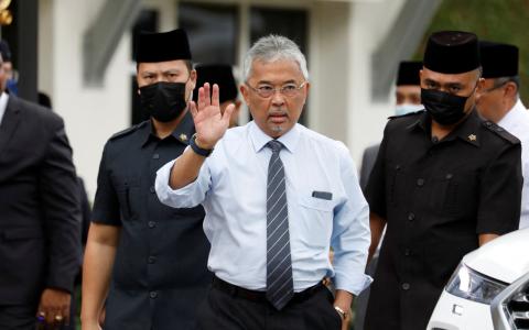 据了解，马来西亚国家元首苏丹阿都拉将就组建联合政府的僵局，征求马来统治者的意见。图为阿都拉21日在国家王宫外，对媒体挥手致意。（路透社）