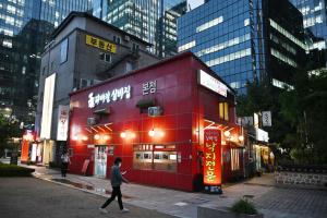 越来越多韩国年轻人回避餐饮、住宿等劳动强度较大的兼职岗位，使外国留学生成为填补劳动力缺口的重要来源。图为位于首尔的一家海鲜餐馆。（法新社）