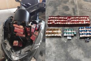 当局在涉案电单车的多个暗格及隔层搜出逾400包私烟。（新加坡移民与关卡局提供）